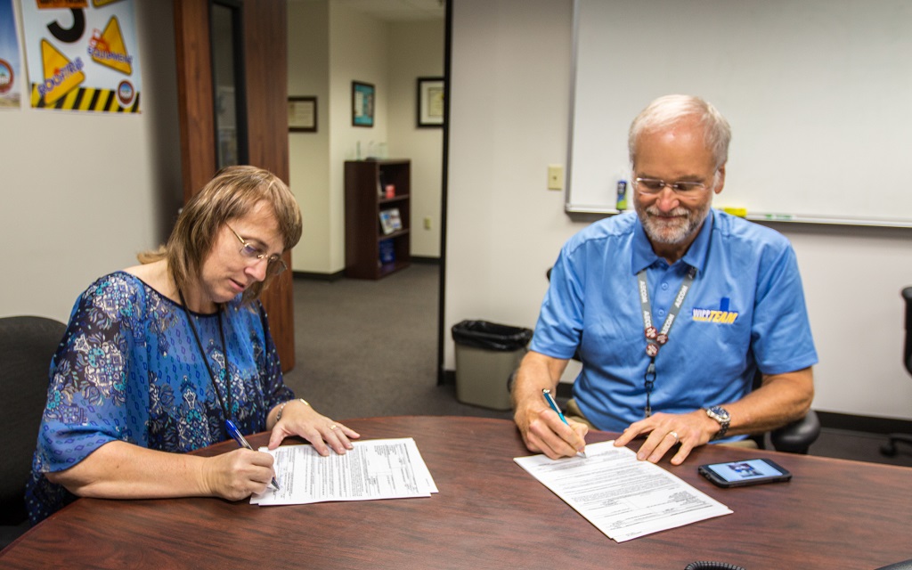 photo of signing of documents between a DOE represenative and a NWP represenative