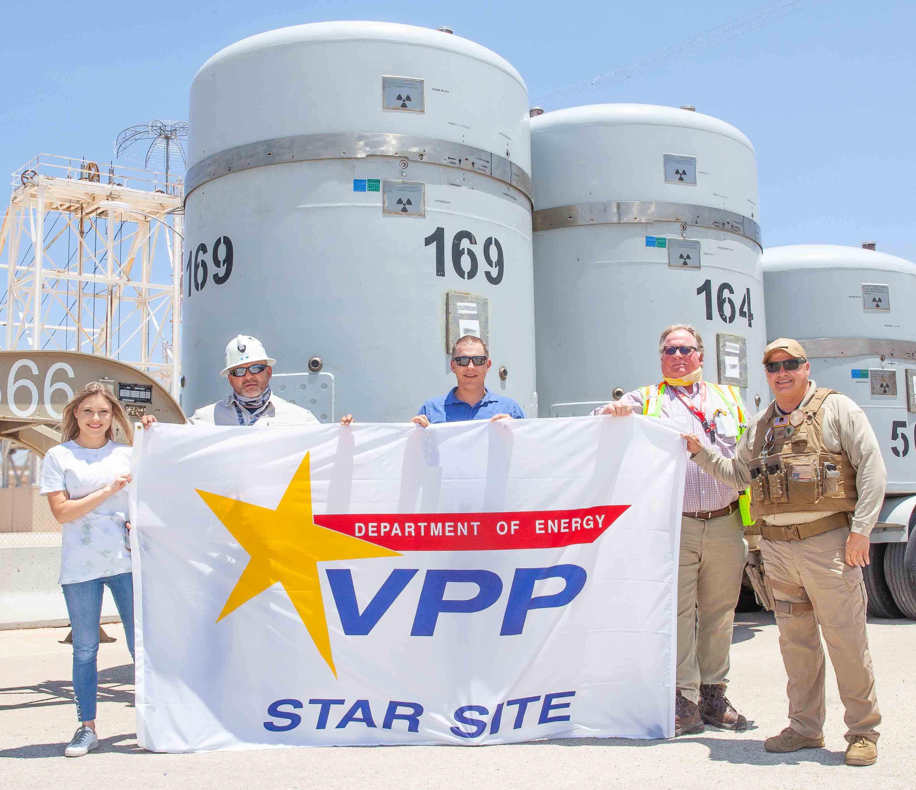 Photo of WIPP employees holding VPP Star Site sign.