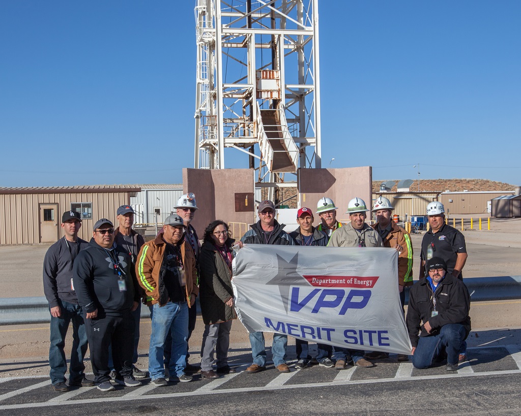 photo of WIPP employees holding a banner that reads Department of Energy VPP Merit Site