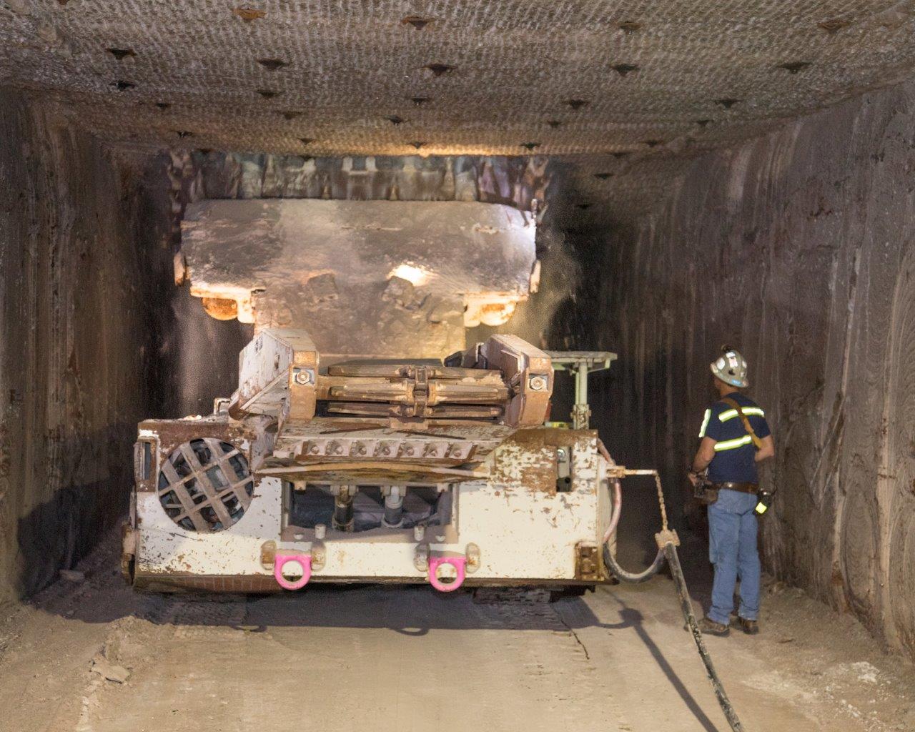 photo of a continuous mining machine with operator