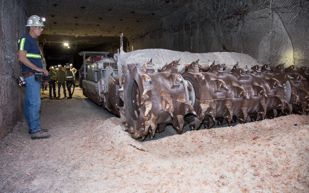 photo of a continuous mining machine with operator in the panel