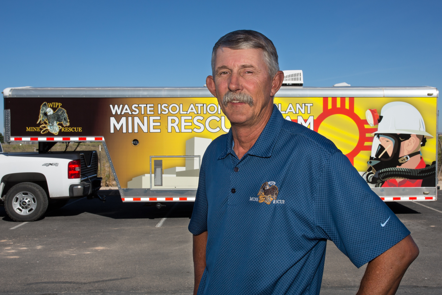 photo of Richard 'Stik' West Standing infront of the WIPP Mine Rescue Truck and Trailer